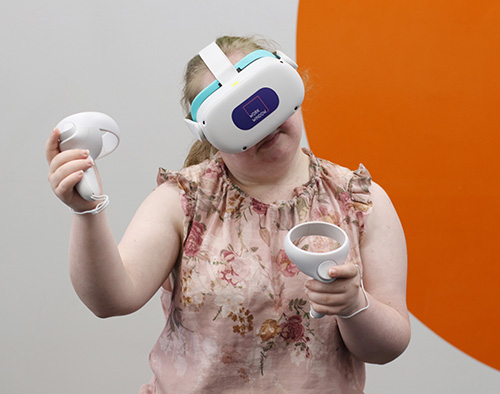 NDIS Participant with VR headset and controllers.